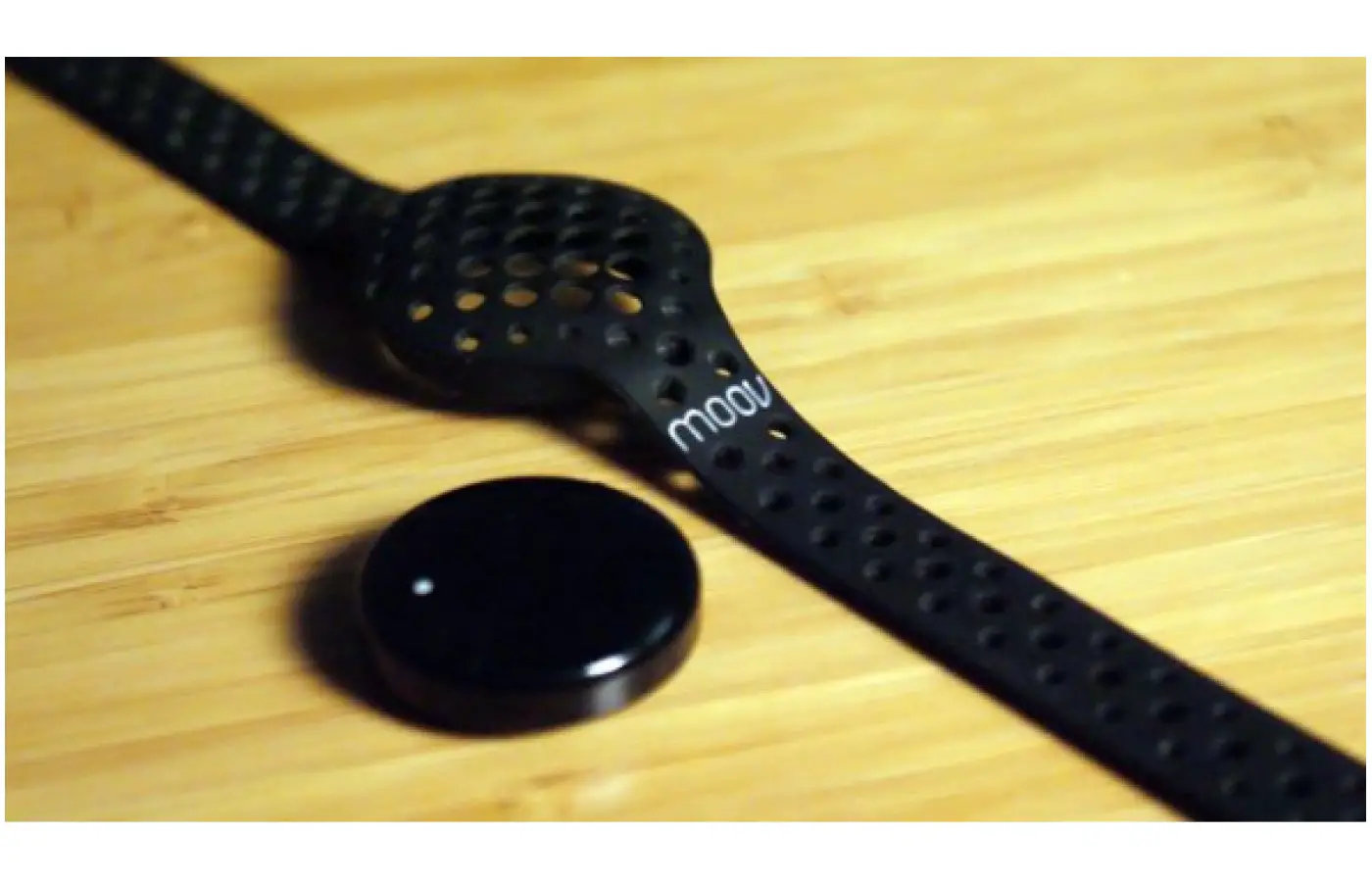 The device is the small disk inserted into a soft rubber wristband.