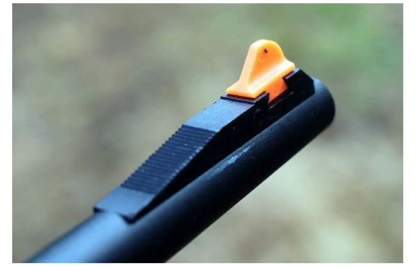 The bright orange front sight insert is dovetail secured and easily picks up the peep-style aperture in the rear.
